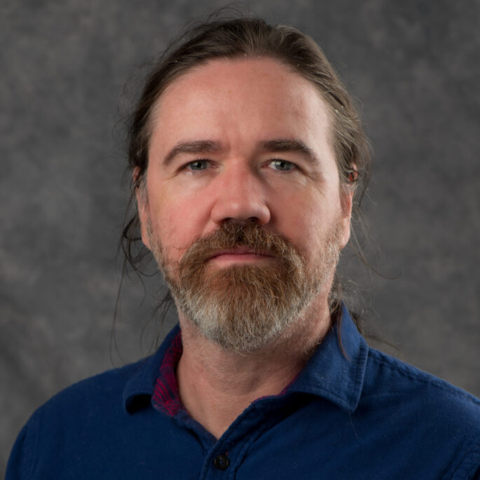 portrait photo of Chris Mungall with dark and gray hair and goatee beard.