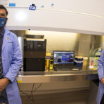 Subhash Verma, associate professor of microbiology and immunology (left) and Timsy Uppal, research scientist, department of microbiology and immunology (right) pose with a dry-sanitizing device.