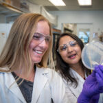 2019 SULI intern Katie Stephens and mentor Deepika Awasthi examine a Petri dish