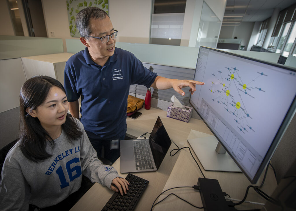 Yuguo Tang (seated), SULI Summer 2023 Intern, works with mentor Zhong Wang at the Integrative Genomics Building (Building 91),