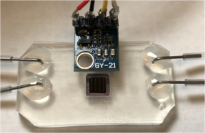 The fluid-holding device designed by Holman and Zhao, which is held in front of an infrared beam to study the change in atomic bonds in sample of molecules. (Credit: Hoi-Ying Holman/Berkeley Lab)