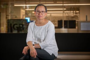 Research Scientist Hualan Liu poses in a lab workspace.