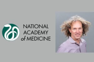 National academy of medicine logo next to a headshot of a man with curly hair